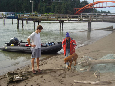 Evan, Britt, and Seeing Eye dog Whit (left to right) stopped at the staging area at the Skagit River System Cooperative to pick up more gear.